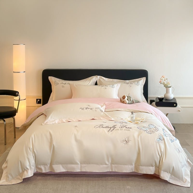 A luxury beige duvet cover set with floral patterns, displayed on a bed in a bedroom setting.