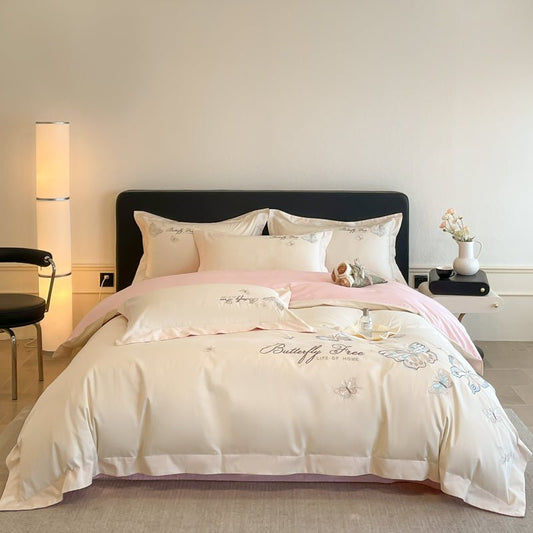 A luxury beige duvet cover set with floral patterns, displayed on a bed in a bedroom setting.
