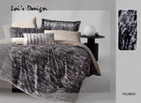 A bedroom scene with a black and white comforter set on the bed, along with matching pillows, bed sheets, and a decorative lamp.