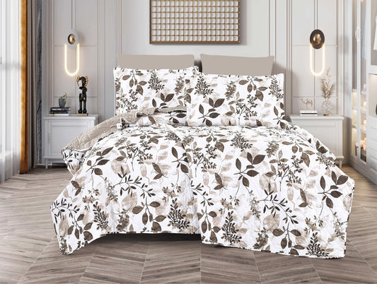 A bed with a white spread featuring a green and brown leaf print, displayed in a room with decorative lighting and a framed picture on the wall.