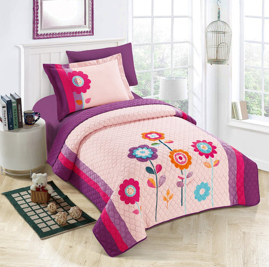 A bedding set with a floral design, featuring a combination of pink, purple, and multicolored flowers on a pink background, displayed in a bedroom setting with a pillow, bedsheet, and comforter.