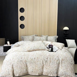 A floral lyocell duvet cover set displayed on a bed with a modern bedroom setting in the background.
