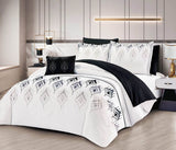 A bedding set with a geometric pattern, featuring a combination of white, black, and gray colors, displayed in a bedroom setting.