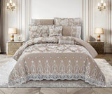 A beige and white lace comforter set on a bed, with additional pillows and decorative bedding, presented in a stylish bedroom setting.