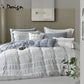 Bedding set with pillows and comforter on a bed, featuring Lei's Design branding.